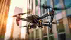 Drone flying in a city in the morning light
