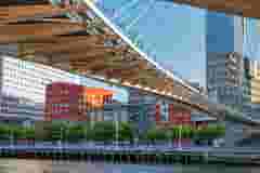 Pedestrian bridge crossing a river ind the city