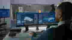 Engineers watching crash test simulation for electric car
