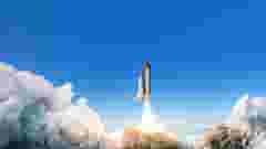 Spacecraft takes off into space. The rocket starts in the blue sky. Travel concept