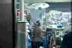 Carrying out an operation using a robot a robot surgeon with manipulators a modern operating room surgeons people perform an operation using a surgeon s robot through the control panel