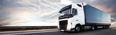 white and grey truck riding on the road