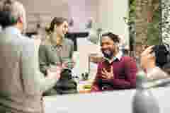 Colleagues laughing while talking to each other