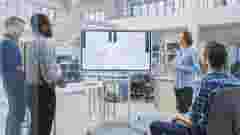 In the In Industrial Design Facility Team of Engineers and Technicians have a Meeting, Female Specialist Leads Briefing, Talks and Draws on Digital Interactive Whiteboard with Car Prototype Concepts