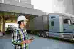 Man checking cargo trucks
