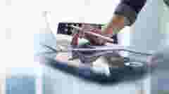 Businessman working on laptop using mobile phone