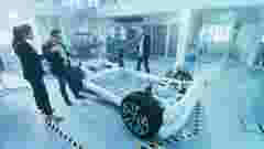 Woman and men with a prototype of a car and simulator