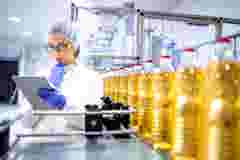 Food factory supervisor holding tablet in food production line factory
