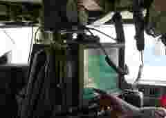 Touch Screen LCD Panel mounted in HMMWV as part of the Blue Force Tracker / FBCB2 system. Soldier is preparing system to go out on a combat patrol.