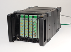 LAN-XI Module 3053-B-120 with Front Panel UA-2107-120, Module 3056-A-040 with Front Panel UA-2111-040 and Battery Module 2831-A in Frame 3660-C-100, front side view, white background with cables