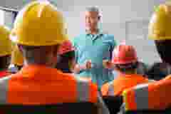 Speaker giving presentation to construction workers