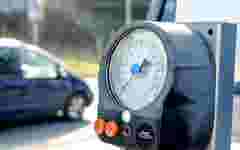 Close up of a tire pressure gauge at a gas station