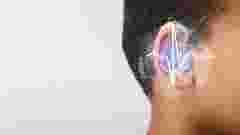 hearing aid tested in an ear, with a graphic of sound waves in front