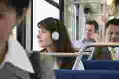 Woman listening to music and looking out train windown
