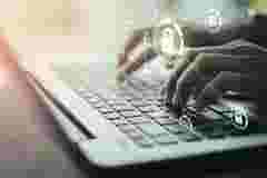 hands typing the keyboard of the laptop with a padlock icon, displayed on a transparent board, surrounded by email, mobile, computer and profile icons