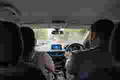 Two Young Adult friends travelling in an EV.