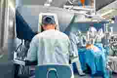 Carrying out an operation using a robot a robot surgeon with manipulators a modern operating room surgeons people perform an operation using a surgeon s robot through the control panel 1