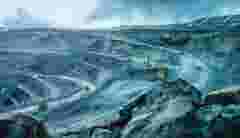 Work of trucks and the excavator in an open pit on gold mining soft focus