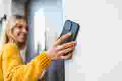 Personal audio Woman using smart lock to enter her flat