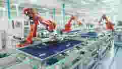 Industrial robots working on assembling solar panels