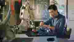 engineer working with cobot side by side with robotic arm