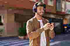 Man with headphones and mobile phone in the street