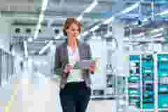 Businesswoman with tablet in a modern factory