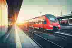 red train on the railway at a station