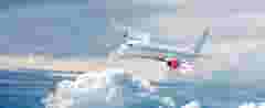 White airplane flying above cloud