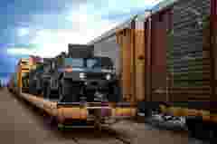Military vehicles loaded on train