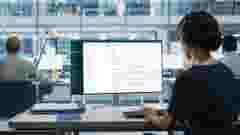 Close Up Over the Shoulder Shot of a Businesswoman Working on Desktop Computer with Finance Statistical Data Software. Digital Projects Manager Typing Data, Using Keyboard and Mouse.